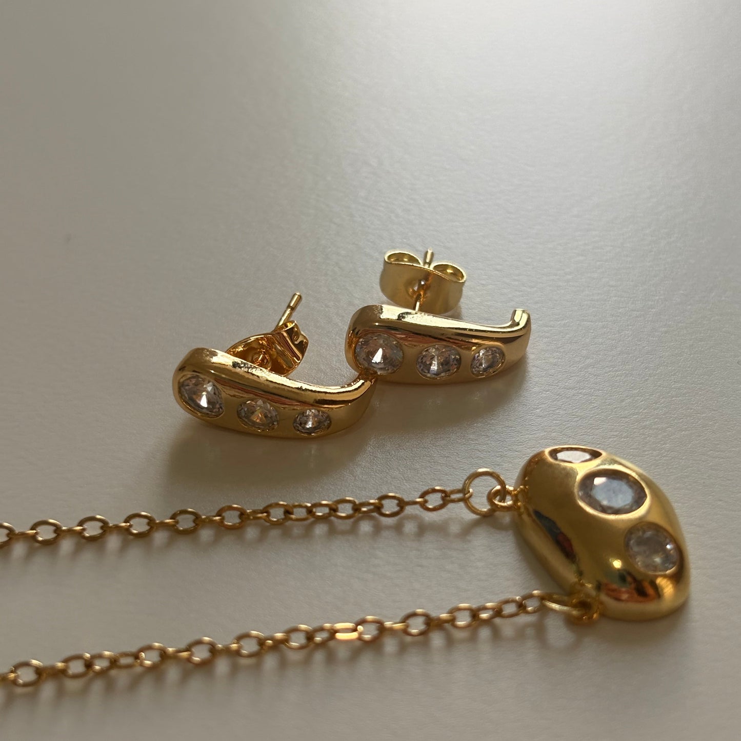 18K gold plated 925 silver melted sculptural stud earrings with three bezel-set zirconia stones